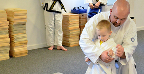 Man And Child Forming A Fist